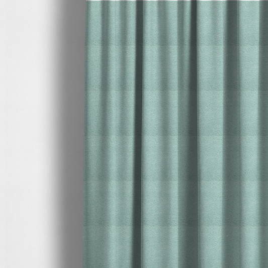 The fabric used to create these made-to-measure curtains is a serene, cool-toned seafoam or soft teal weave with a sophisticated, textured finish.