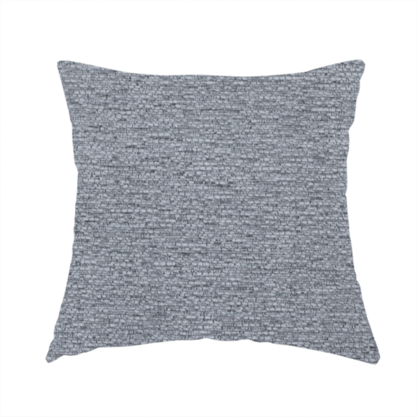 The fabric used to create this handmade cushion is a sophisticated, deep charcoal and slate-grey weave. It features a dense, nubby construction that creates an intricate horizontal ribbing effect, providing significant visual depth and a substantial, inviting tactile quality.