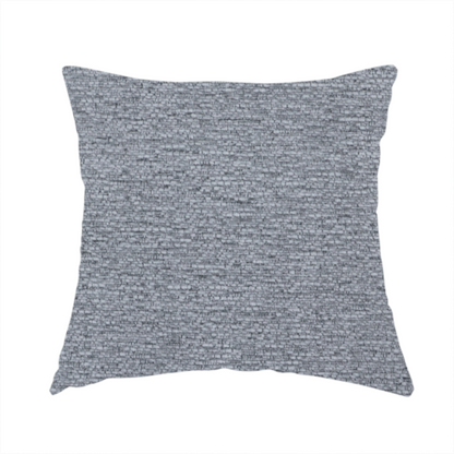 The fabric used to create this handmade cushion is a sophisticated, deep charcoal and slate-grey weave. It features a dense, nubby construction that creates an intricate horizontal ribbing effect, providing significant visual depth and a substantial, inviting tactile quality.