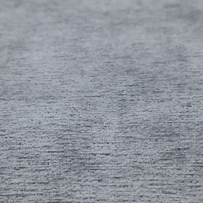 A sophisticated, deep charcoal and slate-grey weave. It features a dense, nubby construction that creates an intricate horizontal ribbing effect, providing significant visual depth and a substantial, inviting tactile quality.