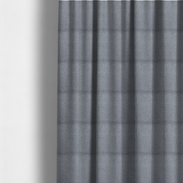 The fabric used to create these made-to-measure curtains is a sophisticated, deep charcoal and slate-grey weave. It features a dense, nubby construction that creates an intricate horizontal ribbing effect, providing significant visual depth and a substantial, inviting tactile quality.