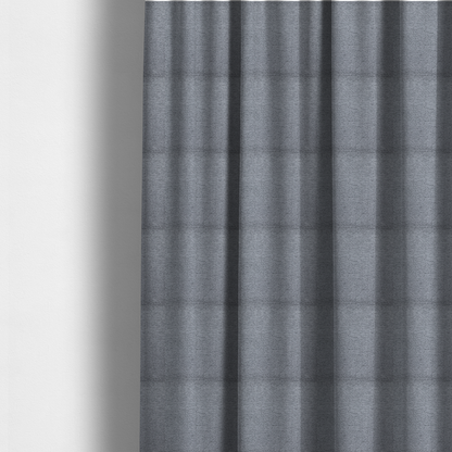 The fabric used to create these made-to-measure curtains is a sophisticated, deep charcoal and slate-grey weave. It features a dense, nubby construction that creates an intricate horizontal ribbing effect, providing significant visual depth and a substantial, inviting tactile quality.