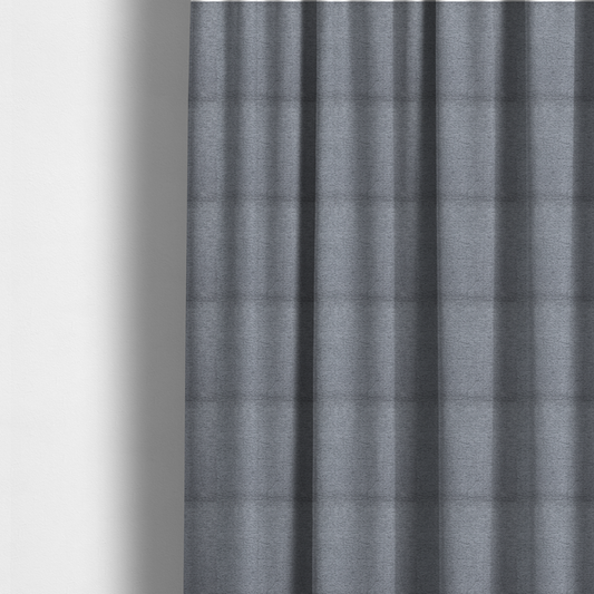 The fabric used to create these made-to-measure curtains is a sophisticated, deep charcoal and slate-grey weave. It features a dense, nubby construction that creates an intricate horizontal ribbing effect, providing significant visual depth and a substantial, inviting tactile quality.