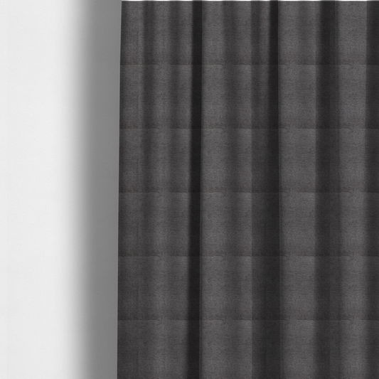 The fabric used to create these made-to-measure curtains is a deep, sophisticated charcoal-grey weave. It is constructed with a dense, nubby texture that creates a subtle, consistent horizontal ribbing effect, providing significant visual depth and a substantial, premium feel.