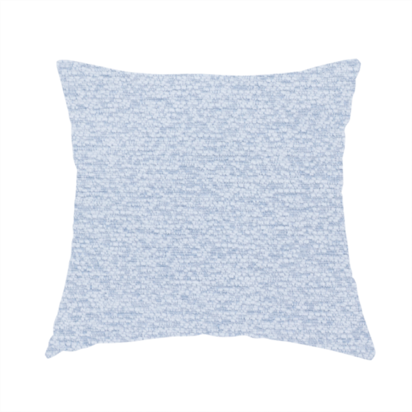 The fabric used to create this handmade cushion is a serene, cool-toned light blue fabric featuring a dense, nubby weave that provides a subtle, calming texture, perfect for adding a touch of tranquil colour and refined style to home upholstery.