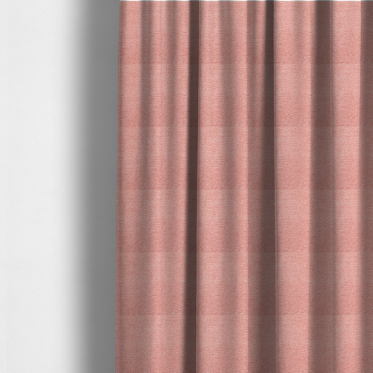 The fabric used to create these made-to-measure curtains is a soft, pastel coral-pink fabric with a dense, nubby textured weave and subtle horizontal ribbing, adding a gentle and welcoming pop of colour to decorative cushions or accent pieces.