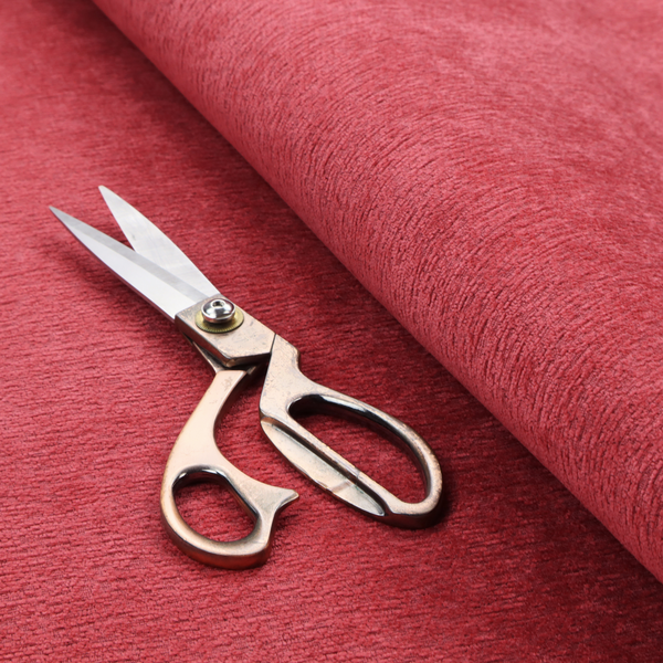 A bold, vibrant crimson-red fabric featuring a dense, nubby texture with a subtle horizontal ribbing effect, providing a dramatic, high-energy focal point perfect for statement upholstery or accent pieces.