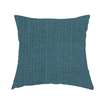 The fabric used to create this handmade cushion is a textured woven fabric in a dusty teal or muted slate blue colour.