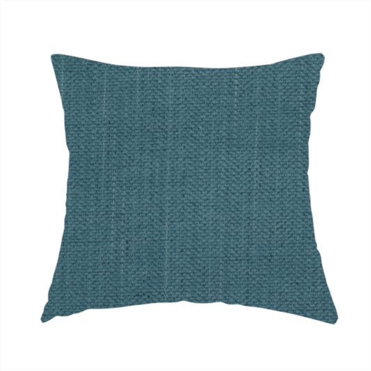 The fabric used to create this handmade cushion is a textured woven fabric in a dusty teal or muted slate blue colour.