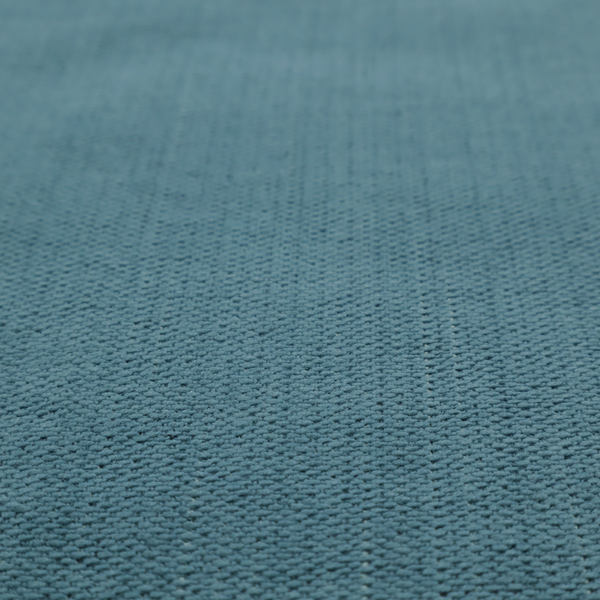 A textured woven fabric in a dusty teal or muted slate blue colour.