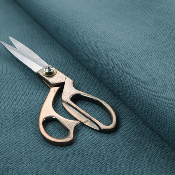 A textured woven fabric in a dusty teal or muted slate blue colour.
