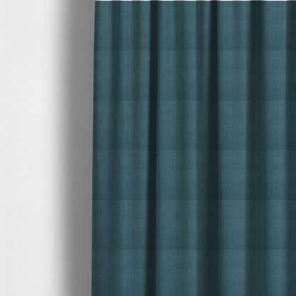 The fabric used to create these made-to-measure curtains is a textured woven fabric in a dusty teal or muted slate blue colour.