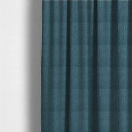 The fabric used to create these made-to-measure curtains is a textured woven fabric in a dusty teal or muted slate blue colour.
