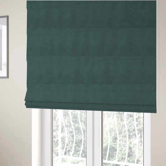 The fabric used to create these Roman blinds is a textured woven fabric in a solid, deep sage green or muted forest green colour.