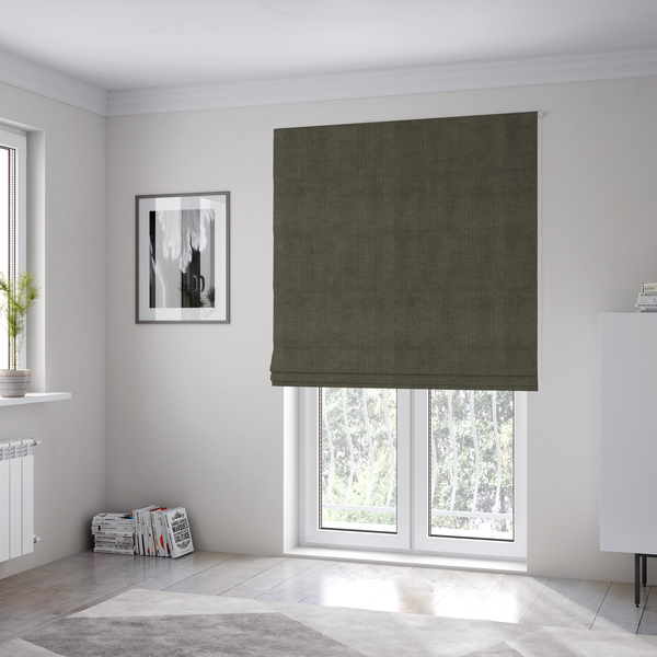 The fabric used to create these Roman blinds is a textured woven fabric in a deep olive green or charcoal-olive hue.