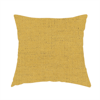 The fabric used to create this handmade cushion is a textured woven fabric in a warm mustard yellow or golden ochre shade.