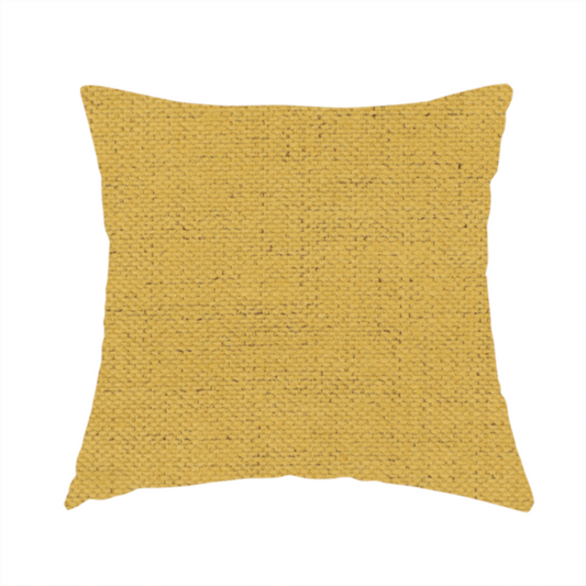 The fabric used to create this handmade cushion is a textured woven fabric in a warm mustard yellow or golden ochre shade.