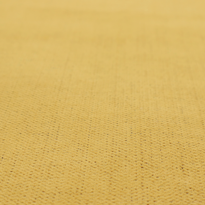 A textured woven fabric in a warm mustard yellow or golden ochre shade.