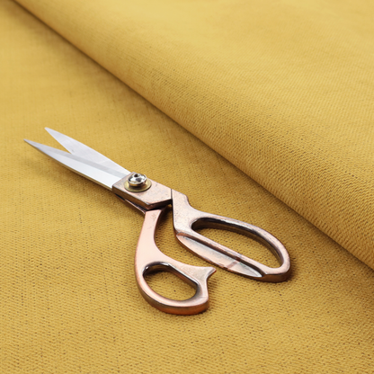 A textured woven fabric in a warm mustard yellow or golden ochre shade.