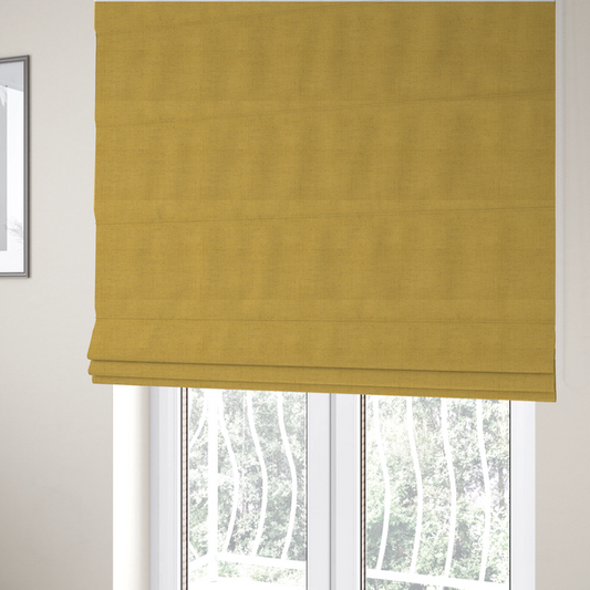 The fabric used to create these Roman blinds is a textured woven fabric in a warm mustard yellow or golden ochre shade.