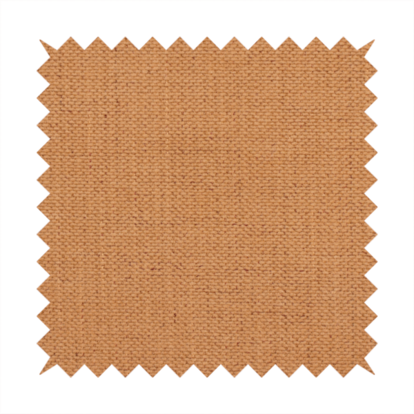 A textured woven fabric in a warm terracotta or soft pumpkin orange shade.