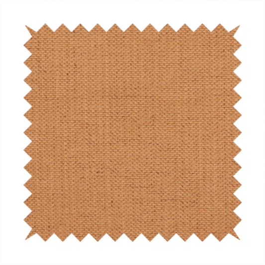 A textured woven fabric in a warm terracotta or soft pumpkin orange shade.