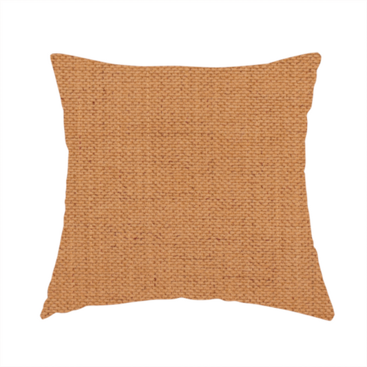 The fabric used to create this handmade cushion is a textured woven fabric in a warm terracotta or soft pumpkin orange shade.
