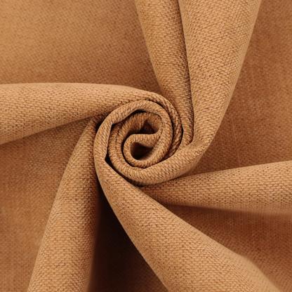 A textured woven fabric in a warm terracotta or soft pumpkin orange shade.