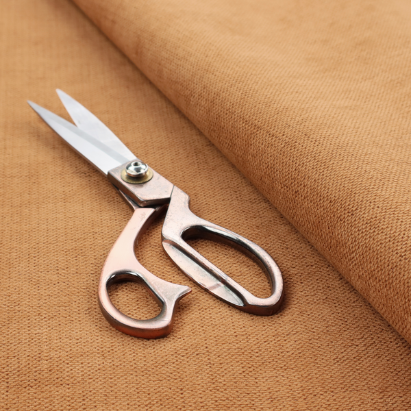 A textured woven fabric in a warm terracotta or soft pumpkin orange shade.