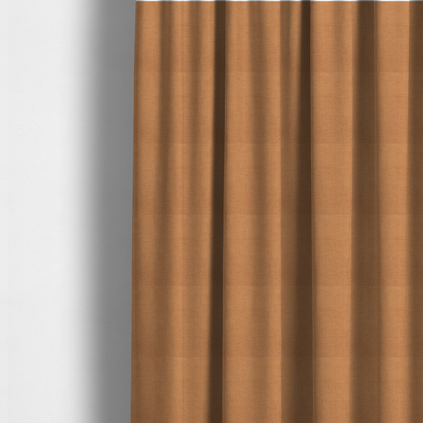The fabric used to create these made-to-measure curtains is a textured woven fabric in a warm terracotta or soft pumpkin orange shade.
