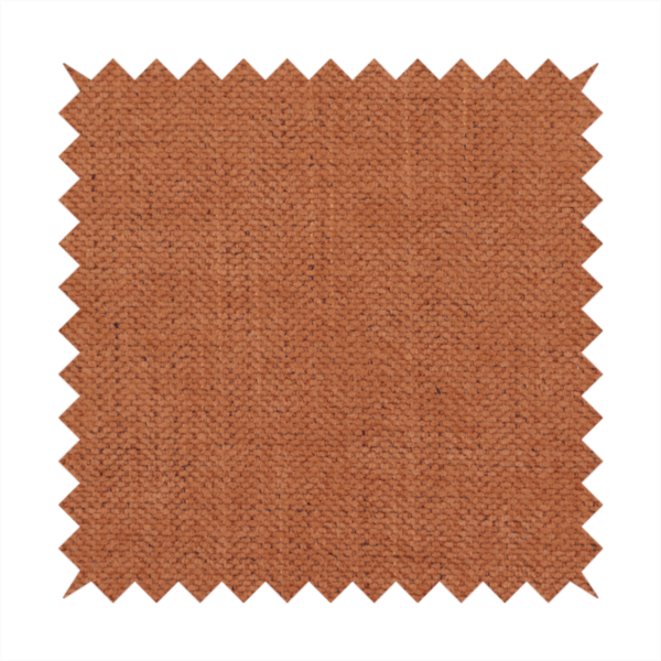 A textured woven fabric in a rich, warm rust or burnt orange shade.