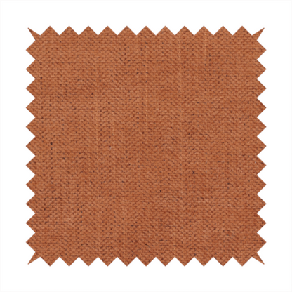A textured woven fabric in a rich, warm rust or burnt orange shade.