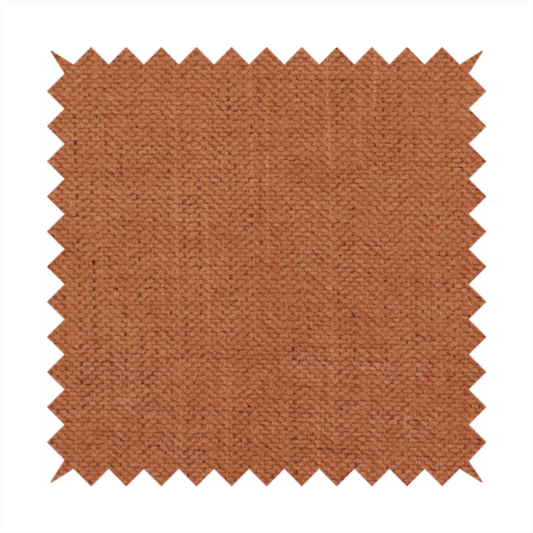 A textured woven fabric in a rich, warm rust or burnt orange shade.