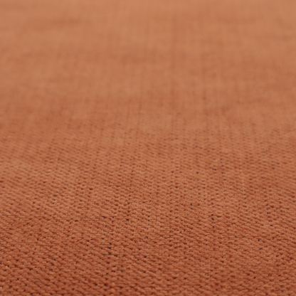 A textured woven fabric in a rich, warm rust or burnt orange shade.