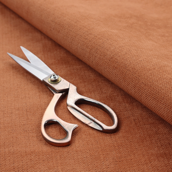 A textured woven fabric in a rich, warm rust or burnt orange shade.