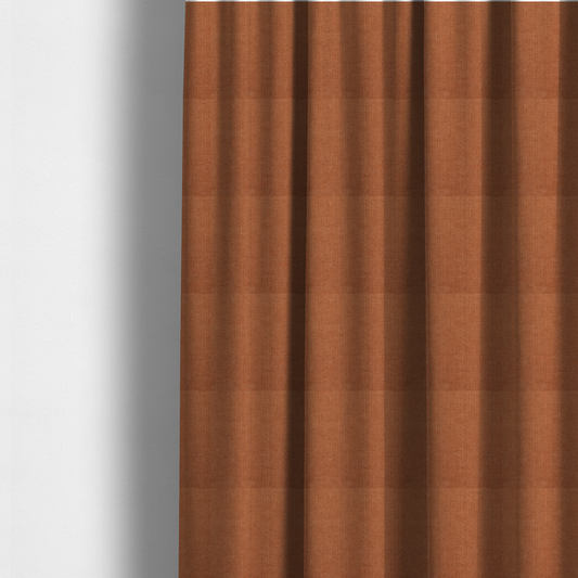 The fabric used to create these made-to-measure curtains is a textured woven fabric in a rich, warm rust or burnt orange shade.