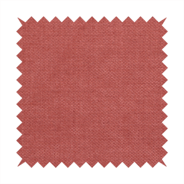 A textured woven fabric in a soft, dusty red or muted brick red shade.