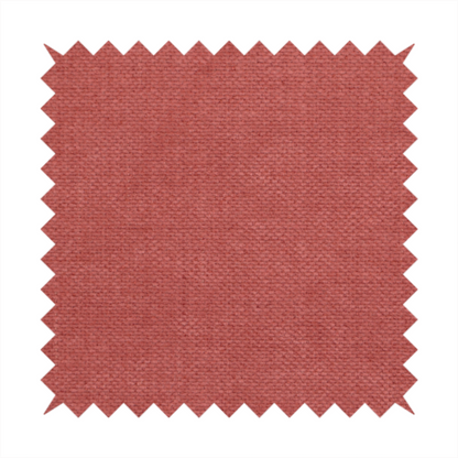 A textured woven fabric in a soft, dusty red or muted brick red shade.