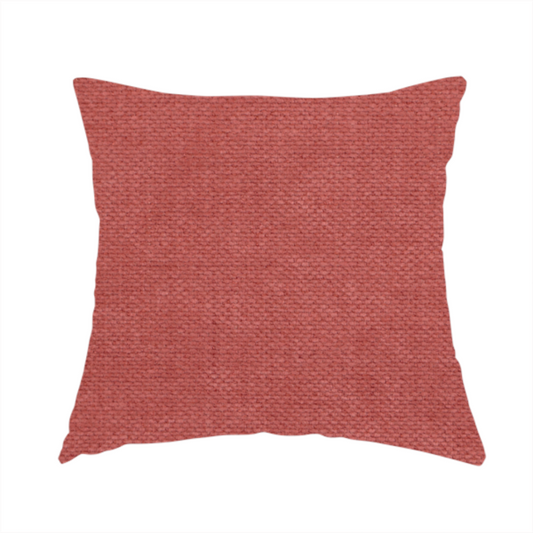 The fabric used to create this handmade cushion is a textured woven fabric in a soft, dusty red or muted brick red shade.