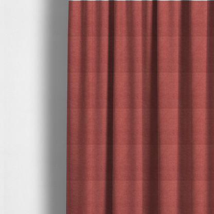 The fabric used to create these made-to-measure curtains is a textured woven fabric in a soft, dusty red or muted brick red shade.