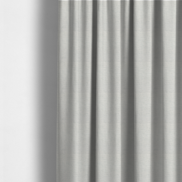 The fabric used to create these made-to-measure curtains is a textured woven fabric in a crisp white or light ivory shade.