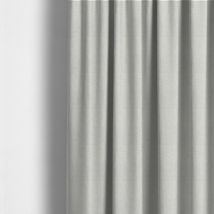 The fabric used to create these made-to-measure curtains is a textured woven fabric in a crisp white or light ivory shade.