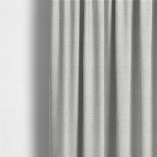 The fabric used to create these made-to-measure curtains is a textured woven fabric in a crisp white or light ivory shade.