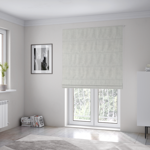 The fabric used to create these Roman blinds is a textured woven fabric in a crisp white or light ivory shade.