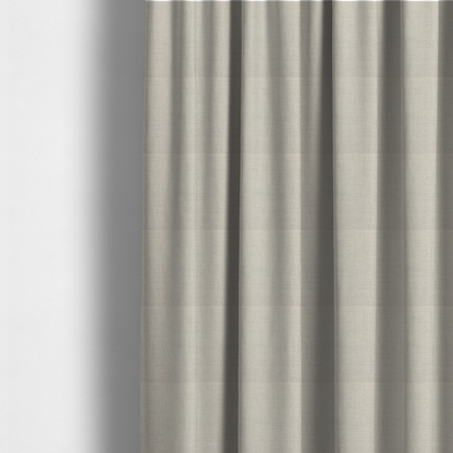 The fabric used to create these made-to-measure curtains is a textured woven fabric in a warm off-white, light cream, or pale beige shade.