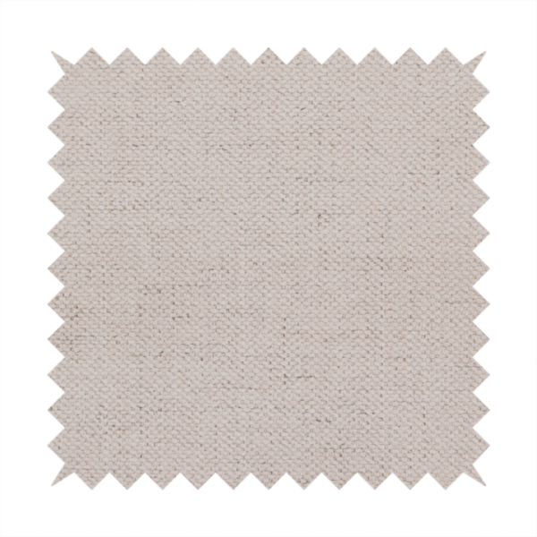A textured woven fabric in a very pale, dusty blush pink or soft ivory shade with a subtle rosy undertone.