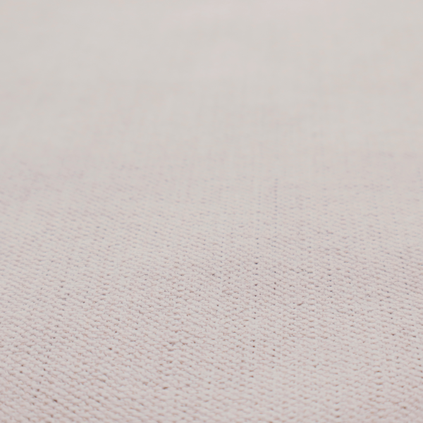 A textured woven fabric in a very pale, dusty blush pink or soft ivory shade with a subtle rosy undertone.
