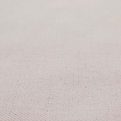 A textured woven fabric in a very pale, dusty blush pink or soft ivory shade with a subtle rosy undertone.