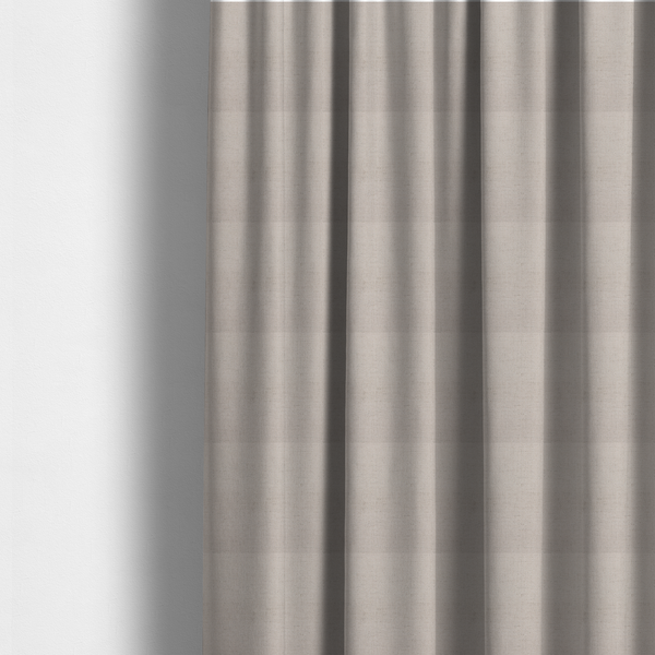 The fabric used to create these made-to-measure curtains is a textured woven fabric in a very pale, dusty blush pink or soft ivory shade with a subtle rosy undertone.