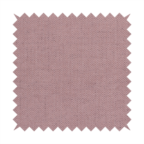 A textured woven fabric in a dusty, muted rose or pale mauve shade.